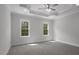 Spacious bedroom with tray ceiling, fan, carpeted floors, and ample natural light from two windows at 106 S Harper Faith Way, Benson, NC 27504