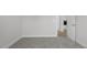 Light-filled bedroom featuring gray carpet and an open doorway at 106 S Harper Faith Way, Benson, NC 27504
