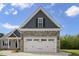 Close-up of the garage featuring a stone facade and upper-story window at 106 S Harper Faith Way, Benson, NC 27504