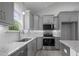Kitchen with granite countertops, gray cabinets, stainless appliances and tile backsplash at 106 S Harper Faith Way, Benson, NC 27504