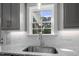 Bright kitchen with granite countertops, subway tile backsplash, and a stainless steel sink at 106 S Harper Faith Way, Benson, NC 27504