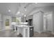 Open-concept kitchen with granite countertops, gray cabinets and decorative ceiling beams at 106 S Harper Faith Way, Benson, NC 27504