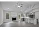 Open-concept living room with fireplace, ceiling fan and gray kitchen with granite countertops at 106 S Harper Faith Way, Benson, NC 27504