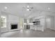 Open-concept living room with fireplace and gray kitchen with granite countertops and stainless appliances at 106 S Harper Faith Way, Benson, NC 27504