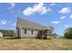 The home's siding complements the peaceful backyard, showcasing the screened porch at 106 S Harper Faith Way, Benson, NC 27504