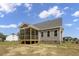 A screened-in porch makes a wonderful transition from the interior to the yard at 106 S Harper Faith Way, Benson, NC 27504