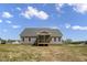 Rear view of the property featuring a cozy screened-in back porch at 106 S Harper Faith Way, Benson, NC 27504