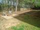 View of a backyard with a cozy fire pit and patio area and surrounding wooden fence at 109 Bright Shade Ct, Holly Springs, NC 27540