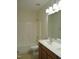 Bathroom featuring double sinks, a shower-tub, and tile flooring at 109 Bright Shade Ct, Holly Springs, NC 27540