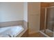 Bathroom featuring a soaking tub with tile surround and a glass shower enclosure at 109 Bright Shade Ct, Holly Springs, NC 27540