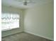 Bedroom featuring neutral carpet, a ceiling fan, and a large window at 109 Bright Shade Ct, Holly Springs, NC 27540