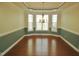 Formal dining room featuring hardwood floors, large bay window, elegant chandelier and crown molding at 109 Bright Shade Ct, Holly Springs, NC 27540