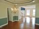 Traditional dining room with hardwood floors and an elegant chandelier creates a warm and inviting ambiance at 109 Bright Shade Ct, Holly Springs, NC 27540