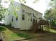 Back exterior view of home with a spacious deck and multi-paned windows at 109 Bright Shade Ct, Holly Springs, NC 27540