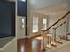 Inviting foyer with hardwood floors, staircase, and natural light from large windows at 109 Bright Shade Ct, Holly Springs, NC 27540