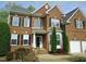 Traditional brick home with a well-manicured lawn, tidy landscaping and an attached two-car garage at 109 Bright Shade Ct, Holly Springs, NC 27540