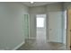 Hallway with neutral walls and carpet leading to rooms with windows at 109 Bright Shade Ct, Holly Springs, NC 27540