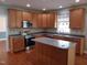 Well-equipped kitchen with stainless steel appliances and a functional island, perfect for culinary enthusiasts at 109 Bright Shade Ct, Holly Springs, NC 27540