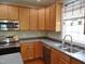Bright kitchen featuring modern appliances, ample cabinet space, and a charming window with hanging plants at 109 Bright Shade Ct, Holly Springs, NC 27540