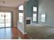 Spacious living room featuring a fireplace, large windows, and hardwood flooring at 109 Bright Shade Ct, Holly Springs, NC 27540