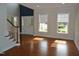 Inviting living room with hardwood floors, natural light from the windows and a staircase at 109 Bright Shade Ct, Holly Springs, NC 27540