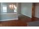 Open concept living area combining dining and living spaces with large windows for natural light and hardwood flooring at 109 Bright Shade Ct, Holly Springs, NC 27540