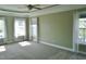Expansive main bedroom with a tray ceiling, plush carpeting, and large windows at 109 Bright Shade Ct, Holly Springs, NC 27540