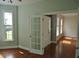 Light filled office featuring hardwood floors, a view through the french doors, and natural light at 109 Bright Shade Ct, Holly Springs, NC 27540