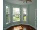 Bright office space with hardwood floors, three large windows, ceiling fan, and transom window at 109 Bright Shade Ct, Holly Springs, NC 27540