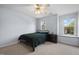 Cozy bedroom with natural light, ceiling fan, and dark green bedding at 11011 Southwalk Ln, Raleigh, NC 27614