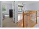 View of bonus room from hallway featuring hardwood floors and large windows for natural light at 11011 Southwalk Ln, Raleigh, NC 27614