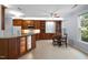 Open kitchen with custom wood cabinets, granite countertops, stainless appliances and a breakfast nook at 11011 Southwalk Ln, Raleigh, NC 27614
