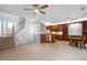 Spacious living area with open floor plan, kitchen, and tile floors with staircase access at 11011 Southwalk Ln, Raleigh, NC 27614