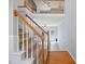 Open staircase with wooden railings overlooking a bright, open-concept living space at 11011 Southwalk Ln, Raleigh, NC 27614