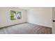 Inviting bedroom featuring soft carpeting, a large window with natural light, and a serene, restful ambiance at 111 Artic Circle, Garner, NC 27529