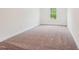Empty bedroom with neutral carpet and a single window at 111 Artic Circle, Garner, NC 27529