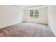Bright and airy bedroom with large window and neutral carpeting at 111 Artic Circle, Garner, NC 27529