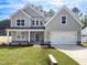 Charming two-story home boasts a well-manicured lawn, attached two-car garage and welcoming entrance at 111 Artic Circle, Garner, NC 27529