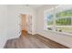 Well-lit office space boasts hardwood floors, large windows offering serene views, and stylish french doors at 111 Artic Circle, Garner, NC 27529