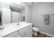 Bathroom featuring white cabinets, double sinks, and a large mirror above the vanity at 121 Viajar Way, Smithfield, NC 27577