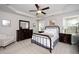 This bedroom features a tray ceiling, carpet, and furniture with dark wood finish at 121 Viajar Way, Smithfield, NC 27577