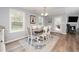 Elegant dining room with large windows and modern decor on luxury vinyl plank flooring at 121 Viajar Way, Smithfield, NC 27577