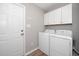 Functional laundry room with washer, dryer, and storage cabinets at 121 Viajar Way, Smithfield, NC 27577