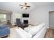 Cozy living room with fireplace, ceiling fan, and comfortable seating at 121 Viajar Way, Smithfield, NC 27577