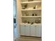 Stylish bar area with built-in cabinets and shelving, perfect for entertaining guests at 1221 Azalea Garden Cir, Raleigh, NC 27603