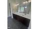 Elegant bathroom features double sinks, stylish vanity, and a soaking tub with a large mirror at 1221 Azalea Garden Cir, Raleigh, NC 27603