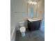 Bathroom featuring a toilet, vanity with a sink, mirror, and a partial view of the tub at 1221 Azalea Garden Cir, Raleigh, NC 27603