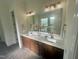 Elegant bathroom featuring double sinks, a large mirror, and modern fixtures at 1221 Azalea Garden Cir, Raleigh, NC 27603