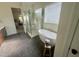 Bright bathroom featuring a soaking tub, tiled flooring, and a glass-enclosed shower at 1221 Azalea Garden Cir, Raleigh, NC 27603