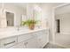 Bright bathroom showcasing double sinks, white cabinets, and a large mirror at 1221 Azalea Garden Cir, Raleigh, NC 27603